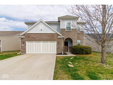 Two-story home featuring brick and siding, attached garage, and well-maintained lawn at 5786 Blue Sky Dr, Whitestown, IN 46075