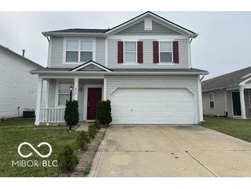 Charming two-story home with gray siding, red shutters, and a well-maintained front yard at 639 Rocky Meadow Dr, Greenwood, IN 46143