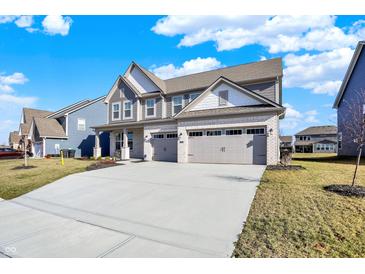 Charming two-story home featuring a two-car garage and a well-manicured front yard on a sunny day at 950 Edmonds Pl, Greenwood, IN 46143