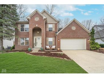 Charming two-story brick home featuring a well-manicured lawn and attached two car garage at 10937 Sawgrass Dr, Fishers, IN 46037