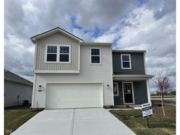 Two-story home showcasing a two-car garage, gray and white siding, and professionally installed landscaping at 11812 Vale St, Indianapolis, IN 46235