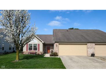 Charming single-story home with attached garage, landscaped lawn, and flowering tree at 1304 Vicksburg S Dr, Greenwood, IN 46143
