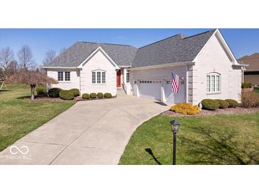 Charming single-Gathering home featuring a well-manicured lawn and an attached two-car garage at 17279 Crescent Moon Dr, Noblesville, IN 46060