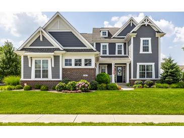 Inviting two-story home with lush green lawn and beautiful landscaping at 3641 Shady Lake Dr, Westfield, IN 46074