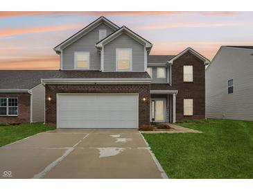 Charming two-story home featuring a two-car garage, brick accents, and a welcoming front lawn at 5150 Bramwell Ln, Whitestown, IN 46075