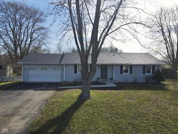 Charming one-story home featuring a two-car garage, well-kept lawn, and neutral colored siding at 589 S 100 W, Franklin, IN 46131