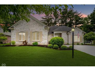 Charming brick home with manicured lawn and beautiful landscaping at 7271 Catboat Ct, Fishers, IN 46038