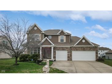 Charming two-story home with brick and siding, showcasing a well-manicured lawn and a two-car garage at 8536 Blue Marlin Dr, Indianapolis, IN 46239