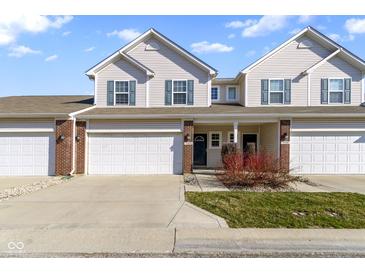 Inviting townhome featuring a two-car garage, charming curb appeal, and a classic facade with stylish accents at 9694 Angelica Dr, Noblesville, IN 46060