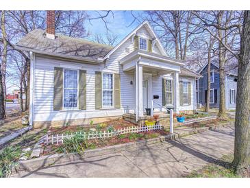 Charming two-story home features a well-manicured front yard and inviting front porch at 110 E Hendricks St, Shelbyville, IN 46176