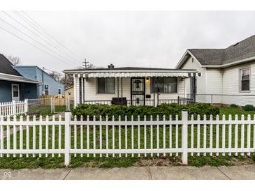 Charming single-story home featuring a white picket fence and covered porch at 1252 Kappes St, Indianapolis, IN 46221