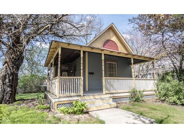 Charming home featuring a welcoming front porch, complemented by mature trees and landscaping at 1542 Maple Ave, Noblesville, IN 46060
