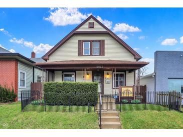 Charming two-story home featuring a well-maintained lawn and a classic design at 2023 Shelby St, Indianapolis, IN 46203