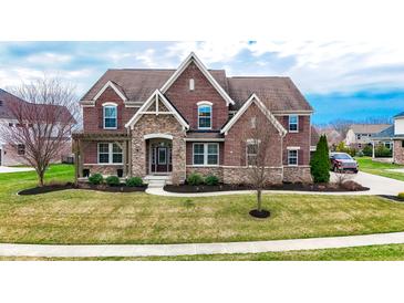 Charming two-story brick home with stone accents, manicured lawn, and well-maintained landscaping at 3240 Wildlife Trl, Zionsville, IN 46077