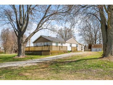 Charming single-story home with a front yard, wooden deck, gravel driveway and storage shed at 3721 S 575 W, Trafalgar, IN 46181