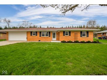 Charming single-story brick home with a well-manicured lawn and attached garage at 3929 Lee St, Anderson, IN 46011