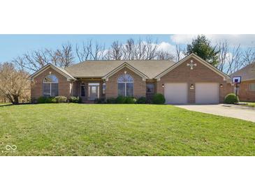 Charming single-story brick home with manicured lawn and two-car garage at 400 S Prairie Trce, Muncie, IN 47304
