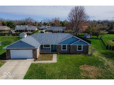 Well-maintained single-story home featuring a brick exterior, attached garage, and a freshly cut lawn at 511 Windward Ln, Plainfield, IN 46168