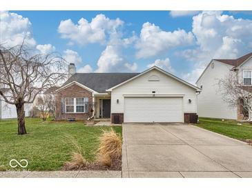 Charming single-Gathering home featuring a two-car garage, brick accents, and a well-maintained lawn at 714 Breakers Ln, Fortville, IN 46040