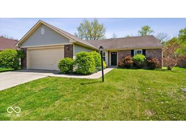 Charming single-story home with brick accents, attached garage, and a well-maintained front yard at 12741 Glengary Dr, Fishers, IN 46038