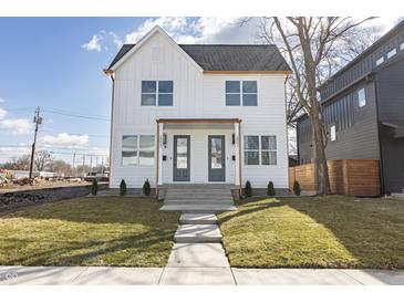 Modern two-story home with white siding, a dark roof, and well-maintained landscaping at 2053 Columbia Ave, Indianapolis, IN 46202