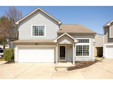Inviting two-story home featuring a one-car garage, charming front porch, and beautifully maintained landscaping at 2421 Grand Fir Dr, Greenwood, IN 46143