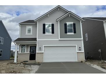 Charming two-story home with a two-car garage, black shutters and light gray vinyl siding at 4523 Laughter Ln, Indianapolis, IN 46235