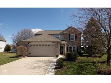 Charming two-story brick home featuring an attached two-car garage and a well-manicured lawn at 4801 Copper Grove Dr, Indianapolis, IN 46237