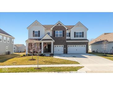 Beautiful two-story home with brick and siding, a three-car garage, and a well-manicured lawn at 5387 Citadel Dr, Noblesville, IN 46062