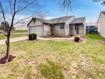 Charming single-Gathering home showcasing stone accents, an attached garage, and a well-maintained front yard at 5927 Timber Lake Blvd, Indianapolis, IN 46237