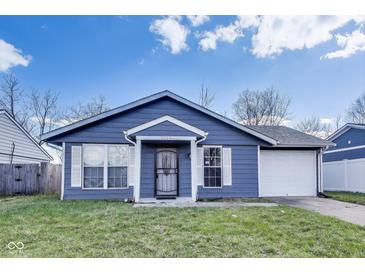 Charming one-story home features a blue exterior, white trim, and an attached one-car garage at 9525 Meadowlark Dr, Indianapolis, IN 46235