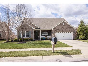 Inviting single-Gathering home with a well-manicured lawn and an attached two-car garage at 9752 Brook Wood Dr, McCordsville, IN 46055
