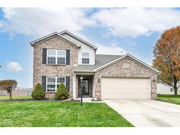 Charming two-story brick home featuring a well-manicured lawn and an attached two-car garage at 14060 Princewood Dr, Fishers, IN 46037