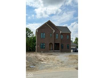 New two-story brick home featuring large windows and an arched front entry at 20598 Chatham Creek Dr, Westfield, IN 46074