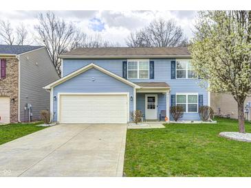 Two-story home featuring light blue siding, an attached two-car garage, and a well-manicured lawn at 4135 Benicia Ln, Indianapolis, IN 46235
