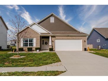 Charming single-Gathering home featuring a brick facade, landscaped yard, and attached two-car garage at 462 N Crystal Dr, Fortville, IN 46040