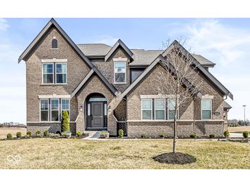 Charming, two-story brick home featuring manicured landscaping and a welcoming entrance at 4763 Denton Dr, Zionsville, IN 46077