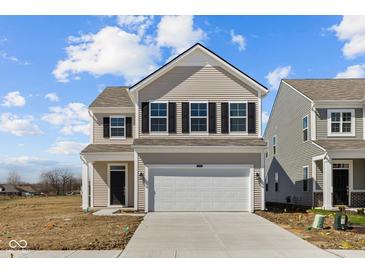 Charming two-story home with beige siding, black shutters, and a two-car garage at 5208 Rolling Meadow Blvd, Indianapolis, IN 46237