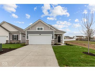 Charming gray home with a two-car garage and well-manicured lawn at 5211 Rolling Meadow Blvd, Indianapolis, IN 46237