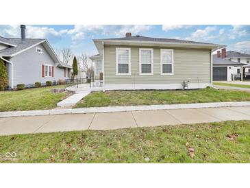 Charming home featuring three pristine windows and a well-manicured lawn at 118 W Fordice St, Lebanon, IN 46052