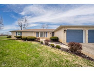 Charming ranch-style home with a brick facade, blue shutters, and an attached two-car garage at 140 Kim Dr, Anderson, IN 46012