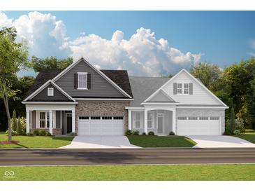 Charming two-story home with brick and siding, featuring a two-car garage and well-manicured lawn at 17220 Cole Evans Dr, Noblesville, IN 46060