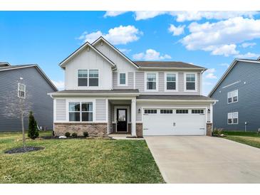 Charming two-story home boasts a two-car garage, a brick foundation, and a well-manicured lawn at 19970 Edwick Dr, Westfield, IN 46074