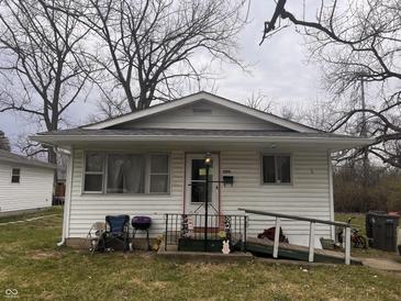 Modest single-story home with vinyl siding, front porch, and a small accessibility ramp at 2194 N Riley Ave, Indianapolis, IN 46218