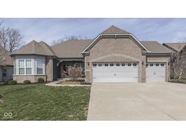 Attractive brick home with a three car garage and well-maintained lawn at 4182 Backstretch Ln, Bargersville, IN 46106