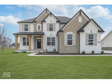 Beautiful two-story home featuring stone accents, black roof, and a well-maintained front yard at 6609 N Dogwood Dr, McCordsville, IN 46055