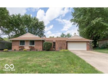 Charming brick home with an attached garage and a well-maintained front lawn at , Indianapolis, IN 46217