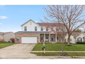 Two-story brick and vinyl home with attached two car garage, covered front porch, and well-kept lawn at 15885 Symphony Blvd, Noblesville, IN 46060