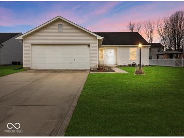 Charming one-story home featuring an attached garage and well-maintained front yard at 1683 Sweetwater Ln, Greenfield, IN 46140