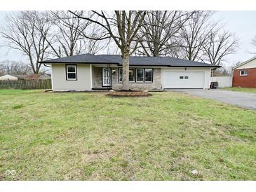 Charming ranch-style home featuring stone accents, black trim, and a well-maintained lawn at 2750 Kristen E Dr, Indianapolis, IN 46218